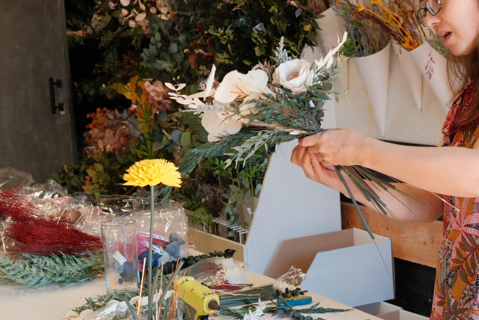 Floral arrangement being created at a tenant workbench
